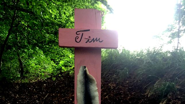 Auf einem rosa Holzkreuz steht der Name Tim