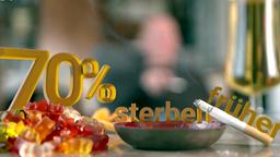 Gummibrchen, Zigarette, Alkohol auf einem Tisch.