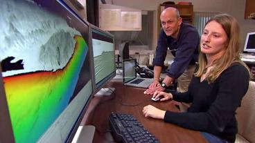 Wissenschaftler des US. Geological Survey vor Bildschirmwand mit geologischen 3D Modellen