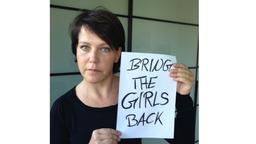 Janina Hartwig mit einem Schild, auf dem geschrieben steht: "Bring the girls back"