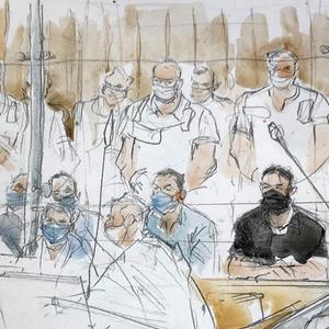 This sketch shows key defendant Salah Abdeslam, in black at right, in the special courtroom built for the 2015 attacks trial, Wednesday, Sept. 8, 2021 in Paris. The trial of 20 men accused in the Islamic State group's coordinated attacks on Paris in 2015 that transformed France opened Wednesday in a custom-built complex embedded within a 13th-ce...