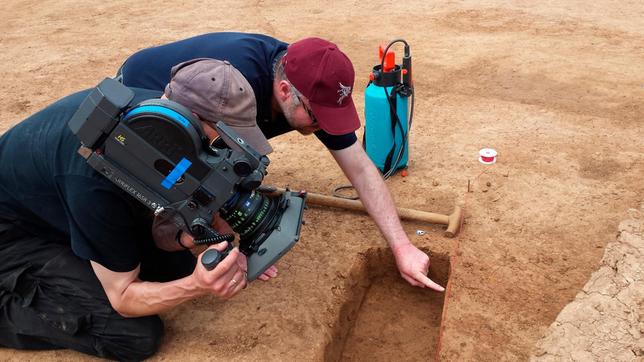 Bild: WDR/Flash Film Maus-Team bei der Arbeit: Regisseur Jan Marschner (hinten) und Kameramann Kai von Westermann (vorne) schauen sich genau an, was die Archäologen ausgegraben haben – an der Erdkante erkennen sie interessante Spuren.