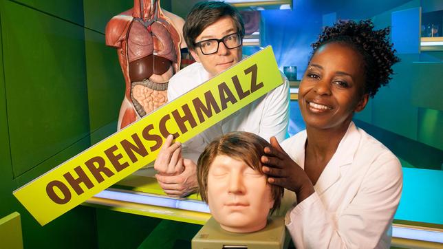Bild: WDR/Thorsten Schneider Shary und Ralph beschäftigen sich heute mit dem Körper und untersuchen das, was er so hergibt. Dabei machen sie vor nichts halt: Sie pulen in Nasen, Augen und Ohren und klären, was Ohrenschmalz und Galle gemeinsam haben. Außerdem geben die beiden Körperforscher Antworten z.b. folgende Frage: Warum hat man fettige Haare?