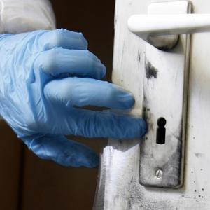 Mit Kohlepulver werden Fingerabdrücke sichtbar gemacht und auf Klebefolie gesichert, Beamter der KTU, Abteilung Kriminaltechnische Untersuchung der Kriminalpolizei, bei der Spurensicherung an einem Tatort.