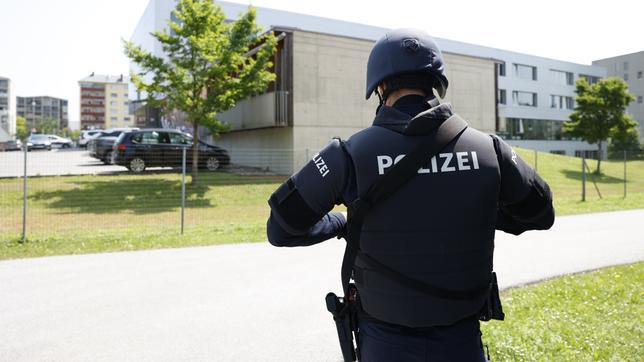 Bild: picture alliance/dpa/APA | Erwin Scheriau Ein Polizist steht in der Nähe des Tatorts – das Bundes-Oberstufenrealgymnasium (BORG) im österreichischen Graz.