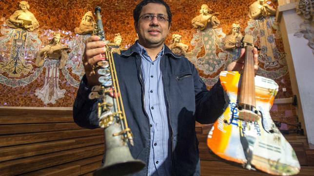 Favio Chavez zeigt zwei Instrumente aus Müll