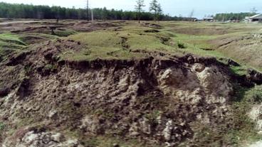 Krater, entstanden durch abgesackten Erdboden