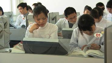 In Weiß gekleidete Leute sitzen in einem Sprachlabor