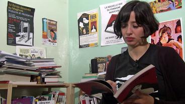 Zainab Fasiki liest in Buch 