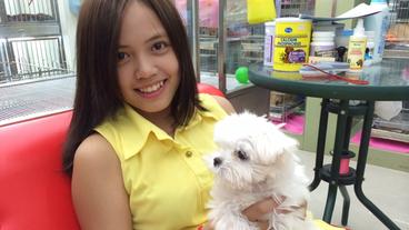 Eine junge Frau mit einem Hund auf dem Arm