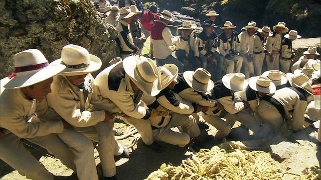 Peruanische Männer ziehen zu mehreren kräftig an einem Seil