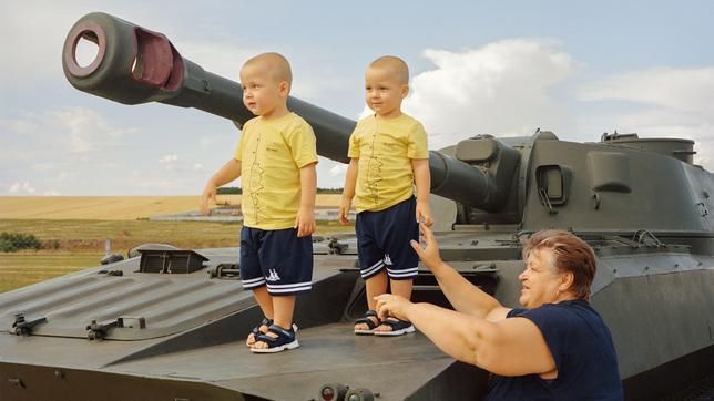 Kleine Kinder stehen auf Panzer