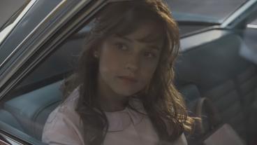 Eine Frau blickt traurig aus einem Auto
