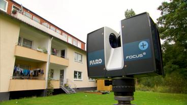 3D-Laserscanner vor einem Wohnblock.