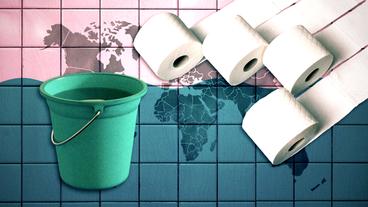 Ein Eimer und Toilettenpapier auf einer Weltkarte