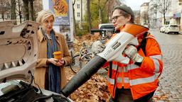 Ralle (Jörn Hentschel) hilft einer Dame (Mareile Blendl) bei der Laubbekämpfung.