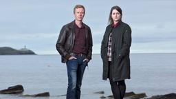 Tosh (Alison O'Donnell) und ihr Kollege Sandy (Steven Robertson) unterstützen Shetland-Ermittler Jimmy Perez, der den 23 Jahre zurückliegenden Mordfall an Lizzie Kilmuir wieder aufrollen muss.