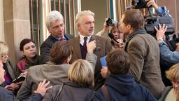 Der nach seiner Verhaftung wieder frei gelassene Museumsdirektor Dr. Gauß (Christoph M. Ohrt) rechtfertigt sich vor der Presse.