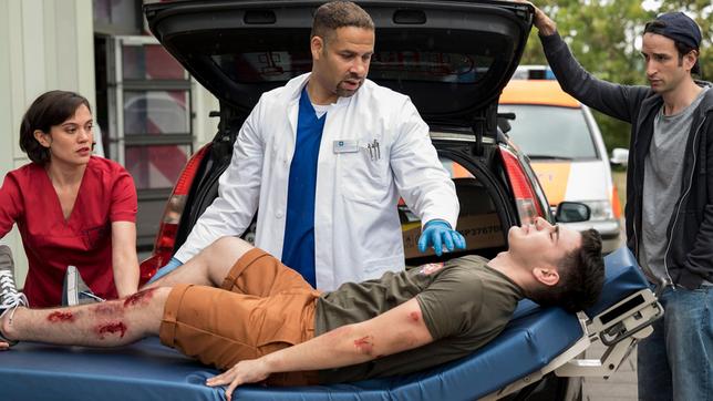 Bild: ARD/Jens-Ulrich Koch Luc Lehmann (Mert Dincer) wird von Josch Widmer (Mehmet Sözer) direkt in die Notaufnahme des Johannes-Thal-Klinikums eingeliefert. Rebecca Krieger (Milena Straube) und Matteo Moreau (Mike Adler) erfahren, dass Luc mit dem Skateboard einen Unfall hatte.