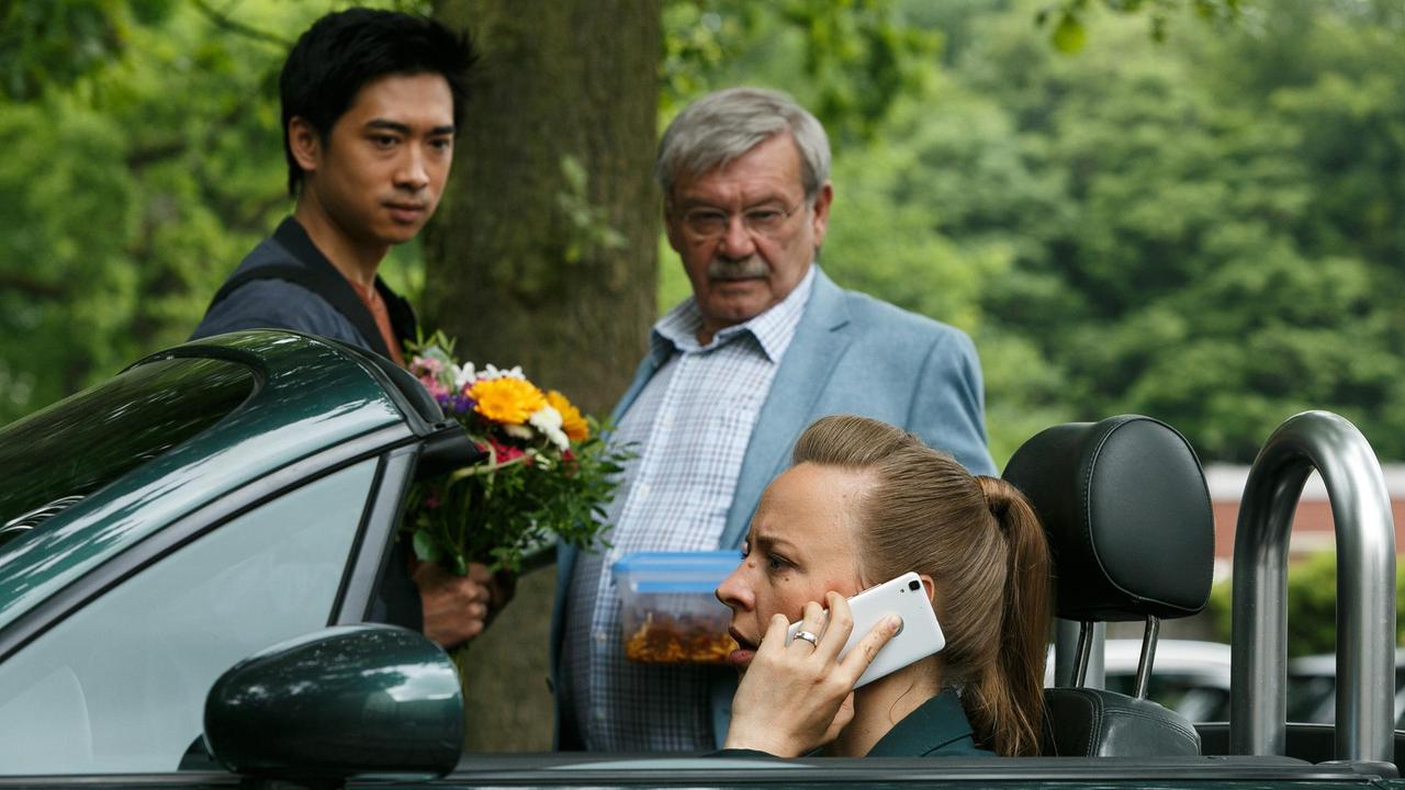 Krankenbesuch:  Hui Ko (Aaron Le), Günter (Wolfgang Winkler) und ihre Chefin Vicky Adam (Katja Danowski) wollen Edwin im Krankenhaus besuchen.