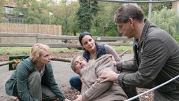 Dr. Fischer liegt am Boden, daneben hocken Anett, Susanne und Conny.