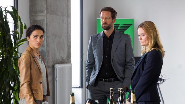 Apathisch schaut Nicole Deetmers (Pauline Knof) ins Leere, während ihr Chef Phil Koslowski (Dominik Maringer) von Jasmin Sayed (Sesede Terziyan), vom Tod seines Kompagnons erfährt.