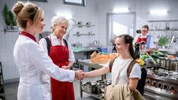 Greta (Laura Osswald, l., mit Antje Hagen) lernt Charly (Natalie Kim Lehmann) kennen. (mit Komparsen)