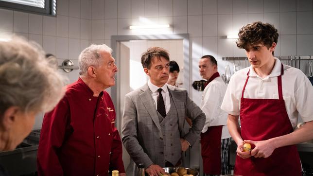 Bild: ARD/Jenrick Mielke Robert (Lorenzo Patané) entlässt Benni (Florian Burgkart) vor André (Joachim Lätsch), obwohl sich Hildegard (Antje Hagen) für ihn einsetzt (mit Komparsen).