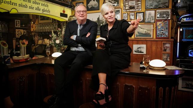 Bild: NDR/Morris Mac Matzen Gastgeberin Ina Müller begrüßt in der hamburger Seemannskneipe ‚Zum Schellfischposten‘ in dieser Sendung den Satiriker und Fernsehmoderator Oliver Welke, und den Autor, Kolumnist und Satiriker Dietmar Wischmeyer, sowie die amerikanische Country-Musik-Sängerin Ingrid Andress mit ihrer Band und die deutsche Band UWE.
